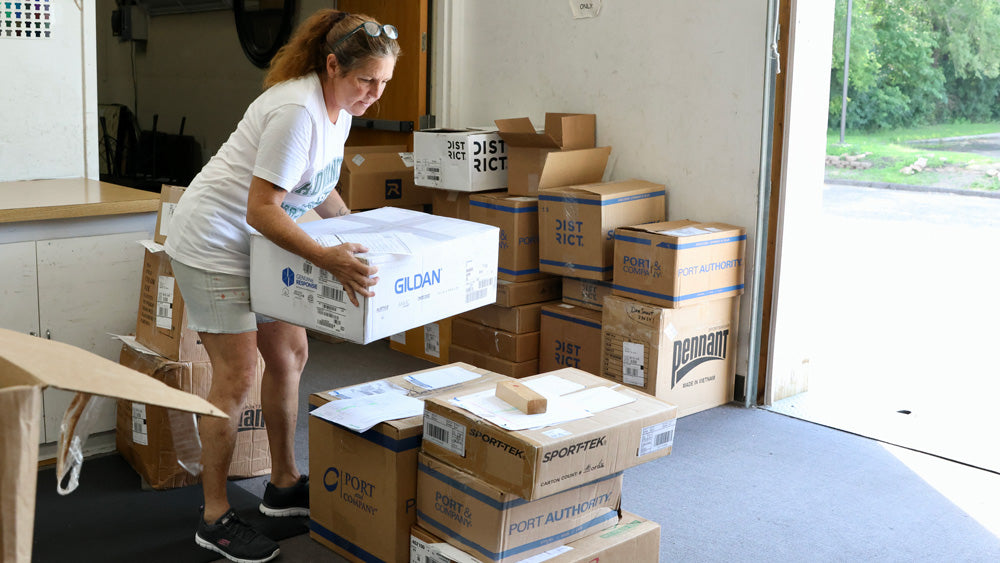 Advanced Sportswear Employee shipping out customers' orders
